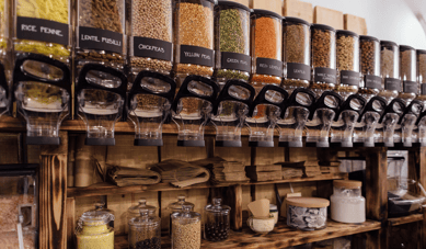 sustainable store design - shelf with raw food product in refillable containers